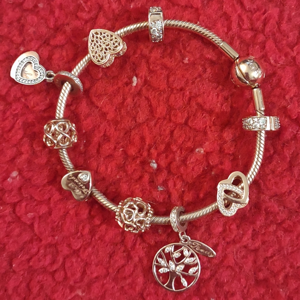 Authentic Pandora Beautiful 14k Rose gold bracelet with customized charms.